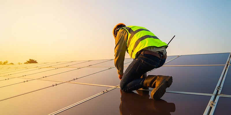 Person working with solar panels