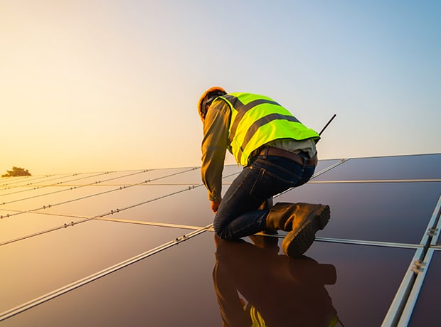 Person working with solar panels