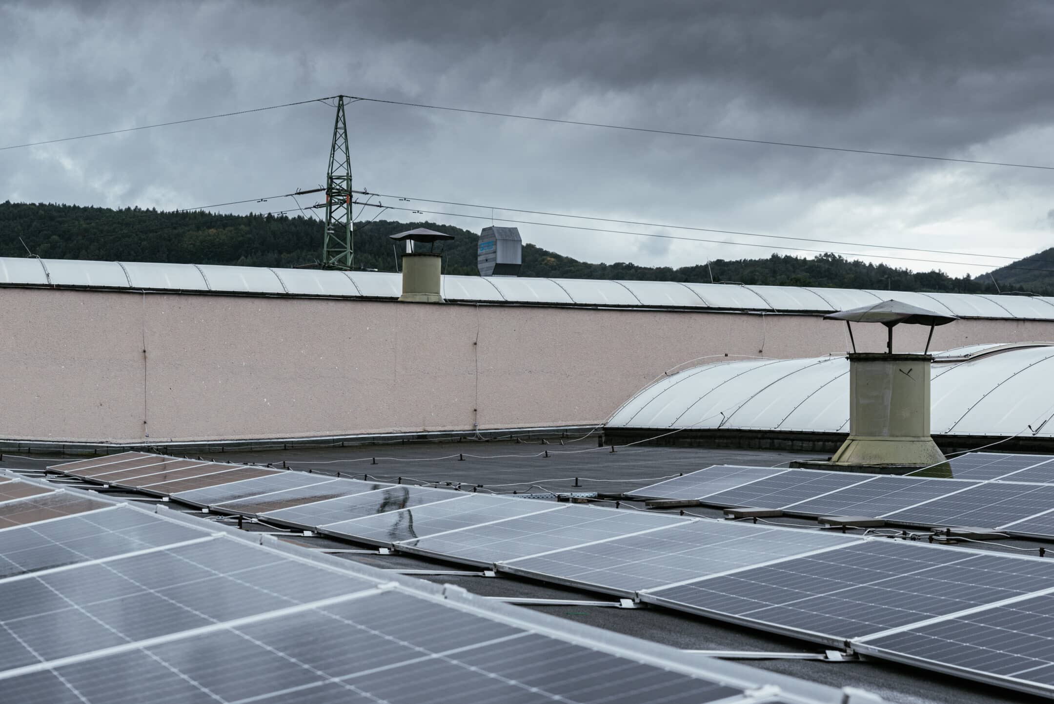 PVs on the rooftop with power tower in the background